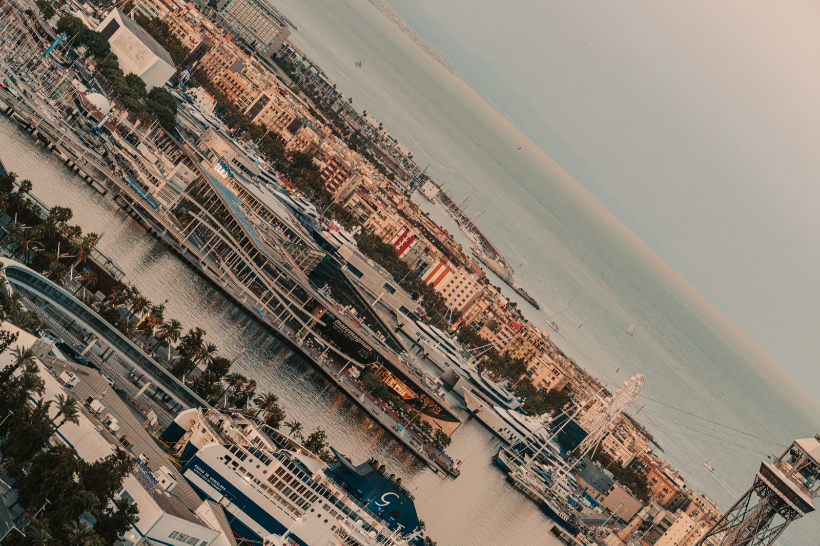 The marina and waterfront of Port Vell, seen at a tilt